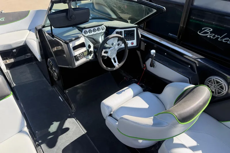 Slide: The Image of 2016 MasterCraft NXT22 boat interior with modern dashboard and white seating. - 14