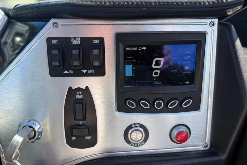 Slide: The Image of Control panel of a 2016 MasterCraft NXT22 boat with digital display and switches. - 16