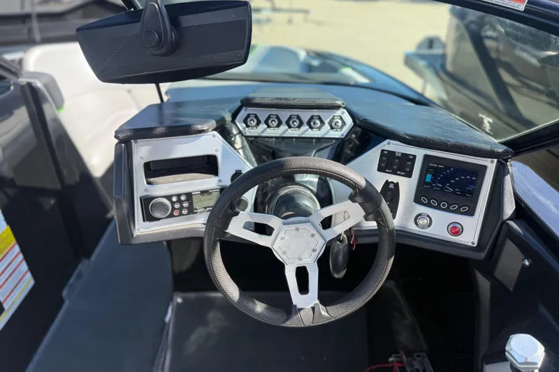 Slide: The Image of 2016 MasterCraft NXT22 boat dashboard with steering wheel and control panel. - 18