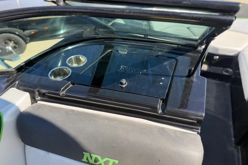 Slide: The Image of 2016 MasterCraft NXT22 boat dashboard with cup holders and NXT logo. - 19