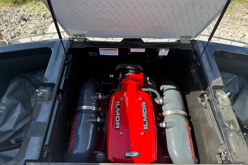 Slide: The Image of 2016 MasterCraft NXT22 engine compartment featuring a red Ilmor engine. - 21