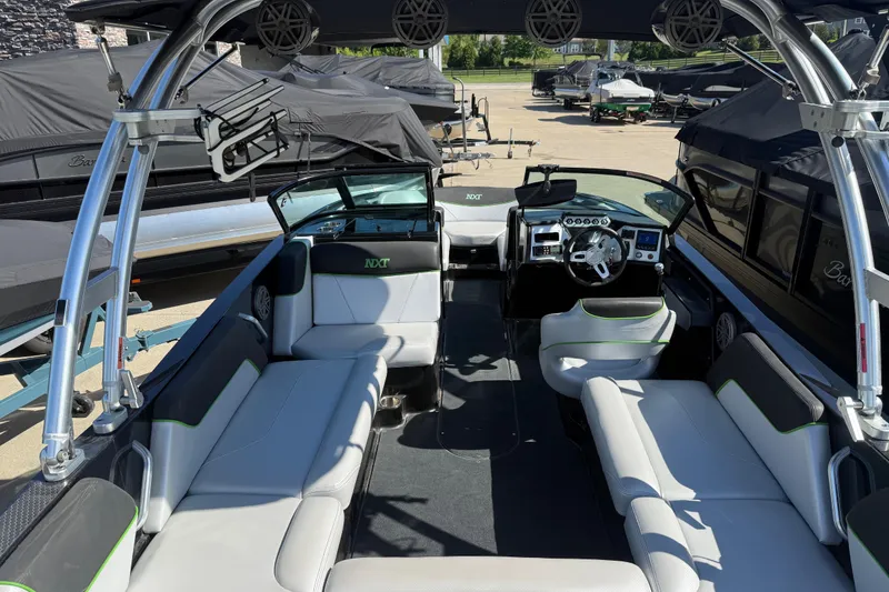 Slide: The Image of 2016 MasterCraft NXT22 boat interior with sleek seating and modern dashboard. - 24