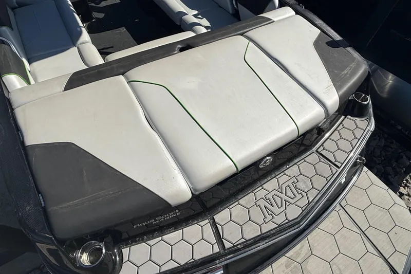Slide: The Image of 2016 MasterCraft NXT22 boat interior with hexagonal pattern and cushioned seating. - 26