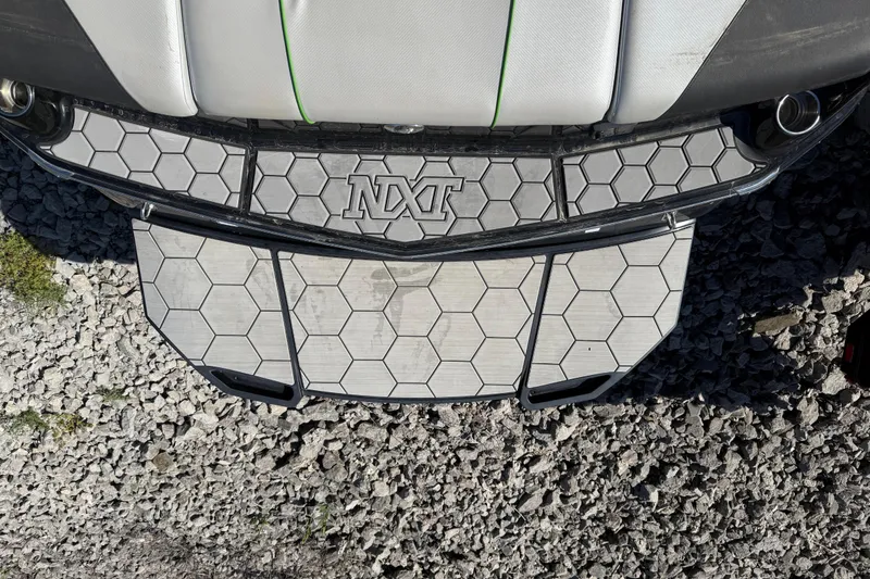 Slide: The Image of 2016 MasterCraft NXT22 boat platform with hexagonal pattern on gravel surface. - 27