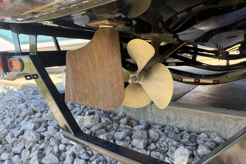 Slide: The Image of Close-up of a 2016 MasterCraft NXT22 boat propeller and rudder on a trailer. - 29