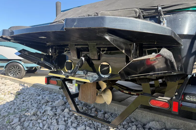 Slide: The Image of Rear view of a 2016 MasterCraft NXT22 boat on a trailer, showing propeller and hull details. - 30