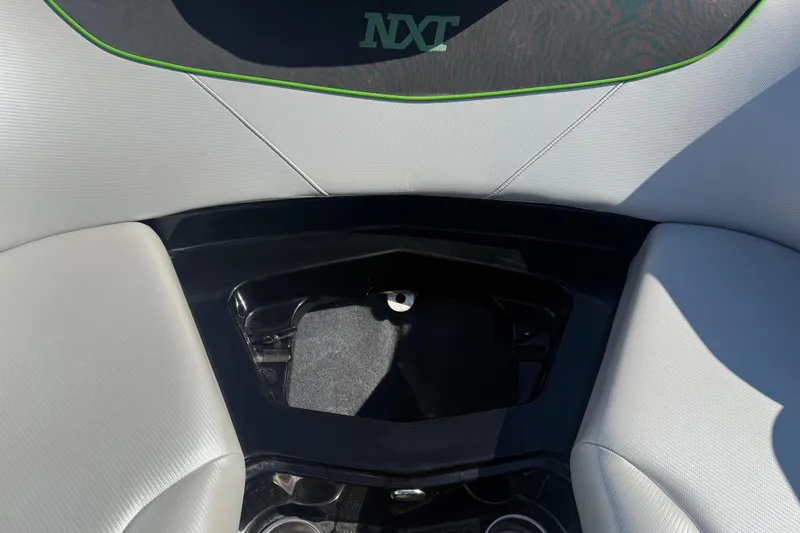 Slide: The Image of Interior view of a 2016 MasterCraft NXT22 boat, featuring sleek seating and storage area. - 4