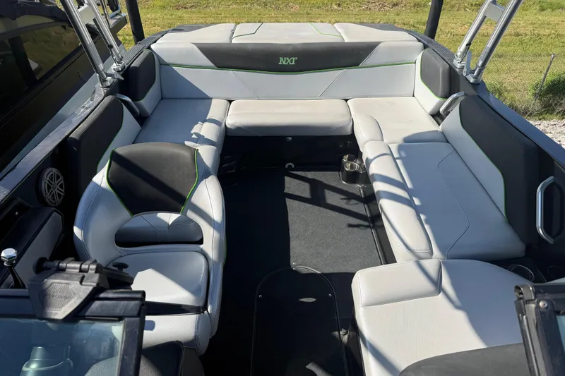 Slide: The Image of 2016 MasterCraft NXT22 boat interior with spacious seating and modern design. - 5