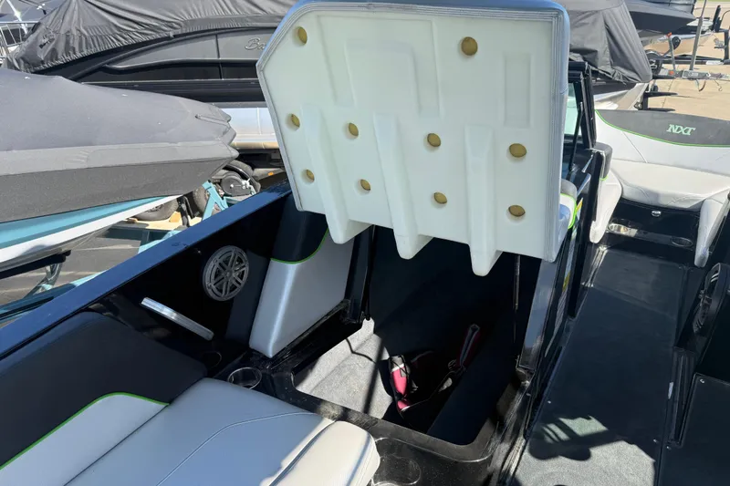 Slide: The Image of 2016 MasterCraft NXT22 boat interior with open storage compartment and seating. - 7