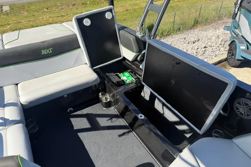 Slide: The Image of 2016 MasterCraft NXT22 boat interior with open storage compartments and seating. - 9