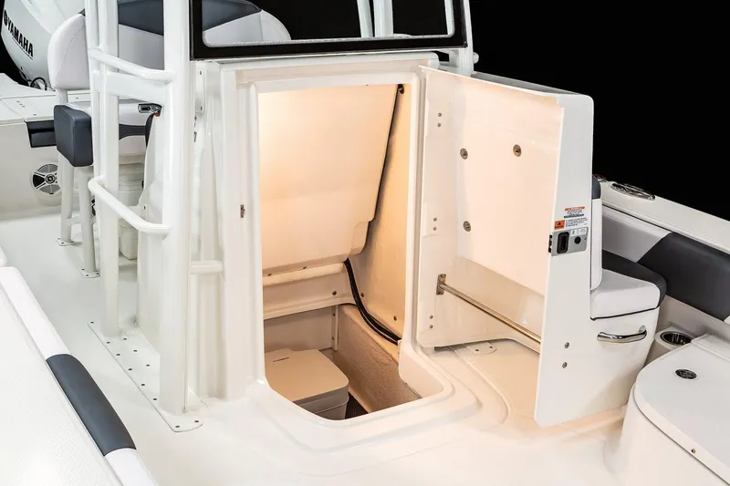 Slide: The Image of Manufacturer Provided Image: 2020 Robalo 246 Cayman SD boat interior storage compartment with lighting. - 18