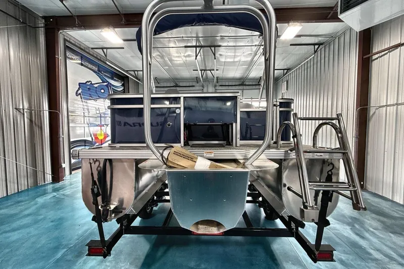 Slide: The Image of 2026 Landau Island Breeze 23F pontoon boat in a showroom, rear view. - 6
