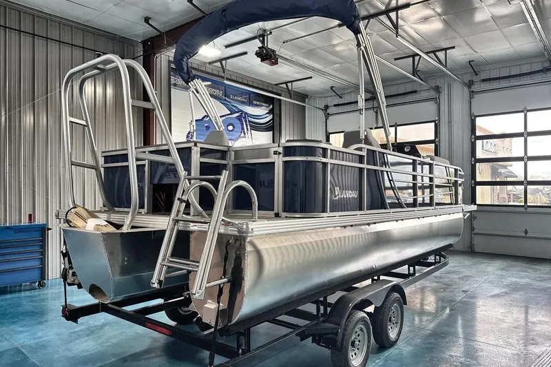 Slide: The Image of 2026 Landau Island Breeze 23F pontoon boat in a garage on a trailer. - 7