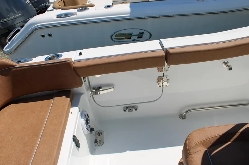 Slide: The Image of Interior view of 2026 Sea Hunt Ultra 255 SE boat with brown seating and stainless steel fixtures. - 11