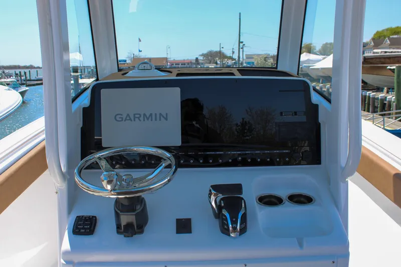 Slide: The Image of Helm of 2026 Sea Hunt Ultra 255 SE with Garmin navigation system and controls. - 2