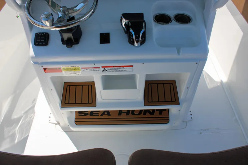 Slide: The Image of Center console of 2026 Sea Hunt Ultra 255 SE boat with steering wheel and controls. - 22