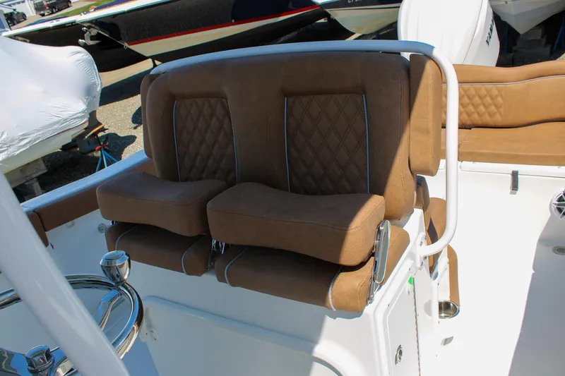 Slide: The Image of Brown cushioned seats on 2026 Sea Hunt Ultra 255 SE boat deck. - 25