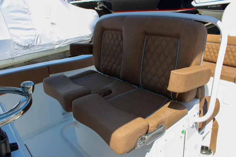 Slide: The Image of Luxurious brown seating on 2026 Sea Hunt Ultra 255 SE boat, featuring diamond stitching. - 27