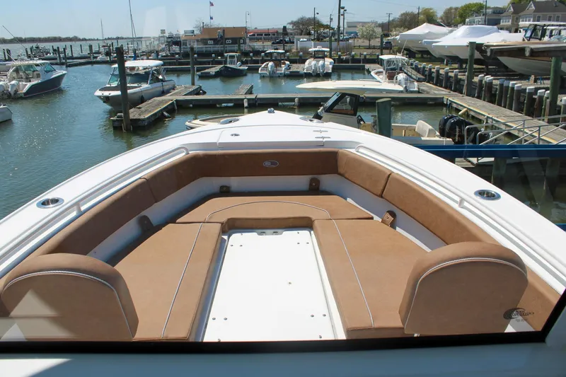 Slide: The Image of 2026 Sea Hunt Ultra 255 SE boat with spacious seating at a marina dock. - 28