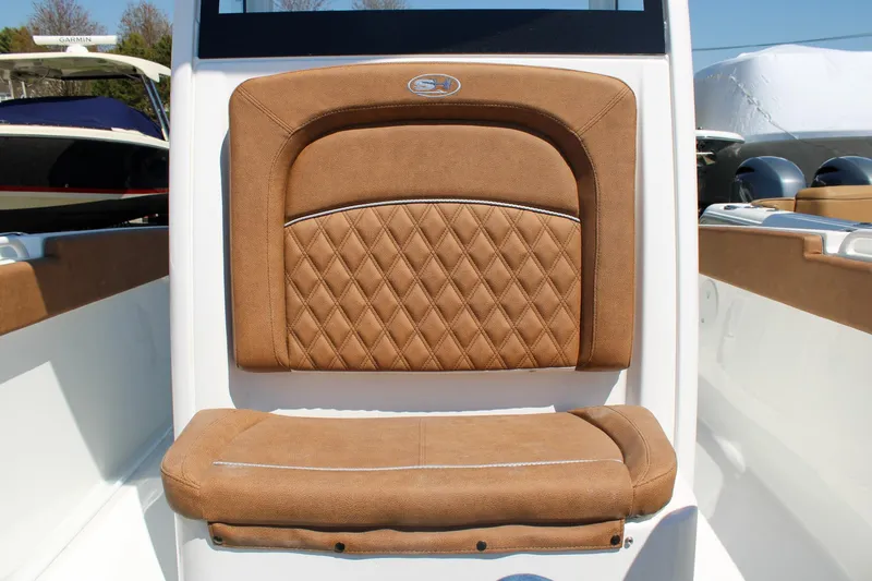 Slide: The Image of 2026 Sea Hunt Ultra 255 SE boat seat with diamond-stitched brown upholstery. - 29