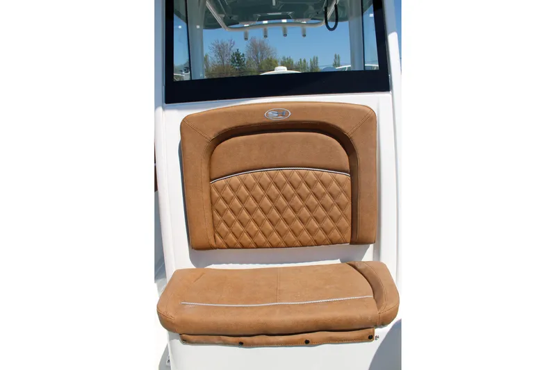 Slide: The Image of Brown cushioned seat on 2026 Sea Hunt Ultra 255 SE boat, featuring diamond stitching. - 30