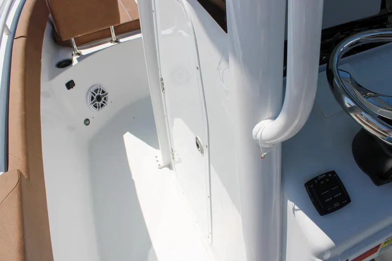 Slide: The Image of 2026 Sea Hunt Ultra 255 SE boat interior with steering wheel and seating area. - 33