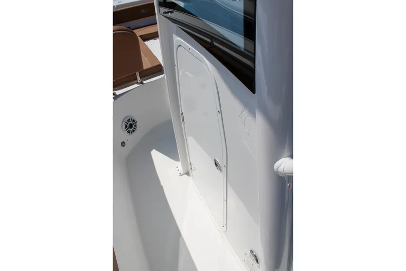 Slide: The Image of 2026 Sea Hunt Ultra 255 SE boat interior with storage compartment and speaker. - 34