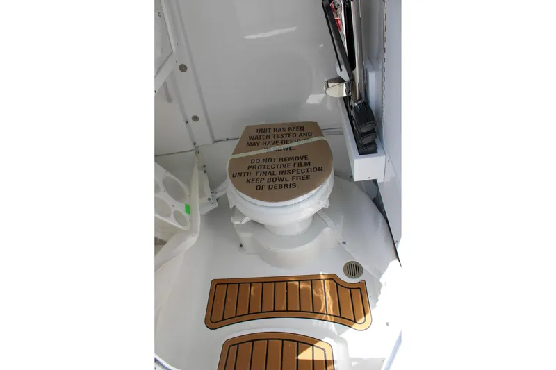 Slide: The Image of 2026 Sea Hunt Ultra 255 SE boat bathroom with toilet and protective film. - 36