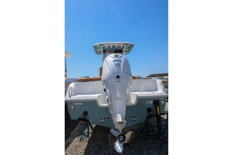 Slide: The Image of 2026 Sea Hunt Ultra 255 SE boat with powerful outboard motor, displayed outdoors. - 38