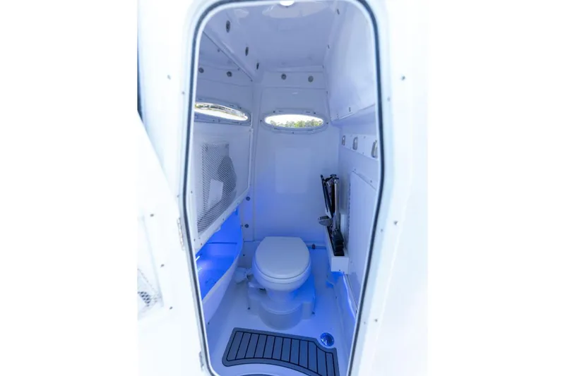 Slide: The Image of Manufacturer Provided Image: 2026 Sea Hunt Ultra 255 SE boat interior with modern marine toilet and blue lighting. - 48