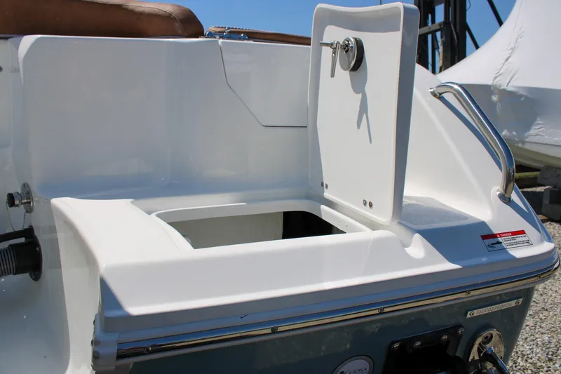 Slide: The Image of 2026 Sea Hunt Ultra 255 SE boat with open storage compartment and stainless steel handle. - 5