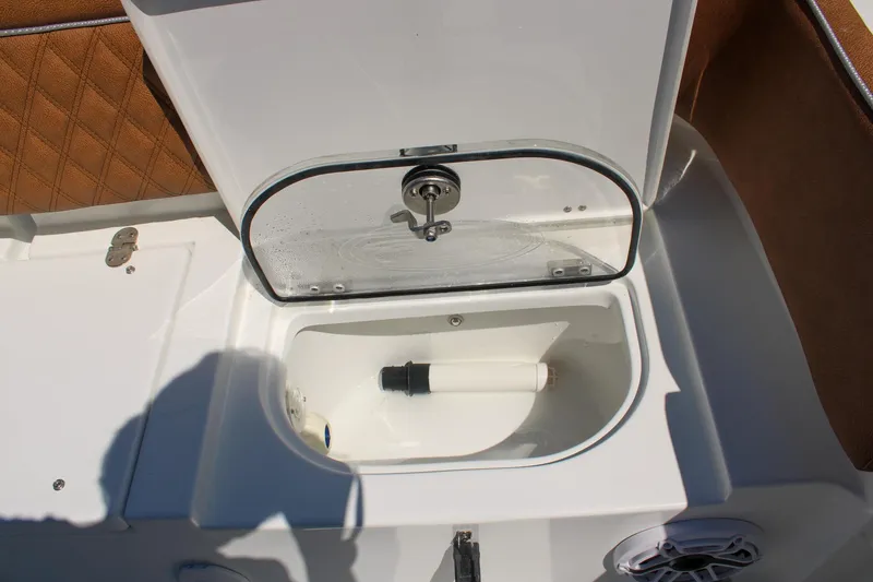 Slide: The Image of Open storage compartment on 2026 Sea Hunt Ultra 255 SE boat. - 8