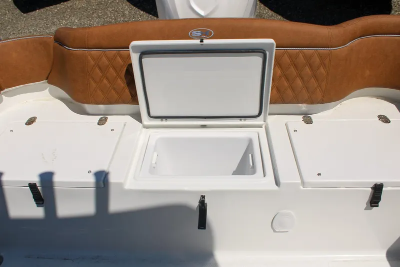 Slide: The Image of 2026 Sea Hunt Ultra 255 SE boat interior with open storage compartments and cushioned seating. - 9