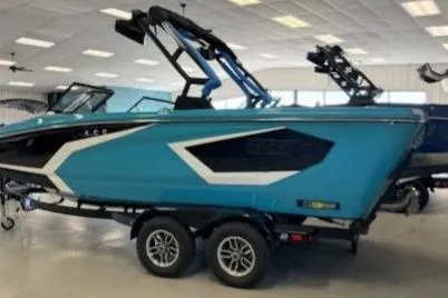 Slide: The Image of 2026 Heyday WT-2DC boat in showroom, featuring sleek blue design and modern wakeboard tower. - 1