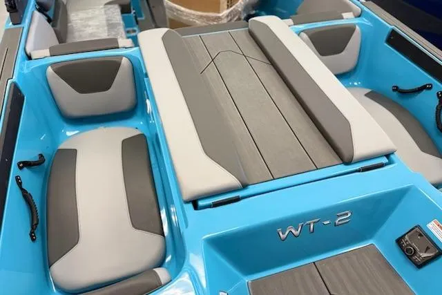 Slide: The Image of 2026 Heyday WT-2DC boat interior with blue and gray seating and deck. - 2