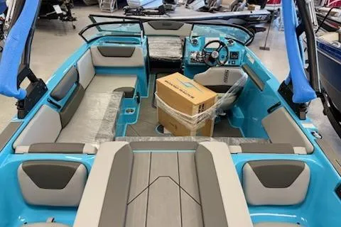 Slide: The Image of 2026 Heyday WT-2DC boat interior with blue and gray seating, displayed in showroom. - 4