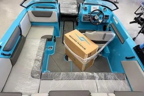 Slide: The Image of 2026 Heyday WT-2DC boat interior with blue accents and packaged board racks. - 5