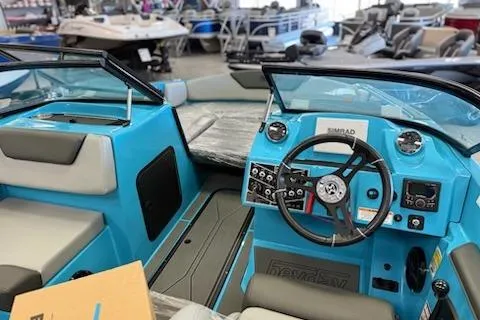 Slide: The Image of 2026 Heyday WT-2DC boat interior with blue dashboard and steering wheel in showroom. - 6