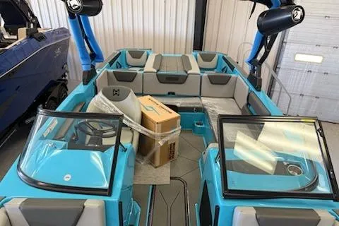 Slide: The Image of 2026 Heyday WT-2DC boat interior with blue and gray seating in a showroom. - 8