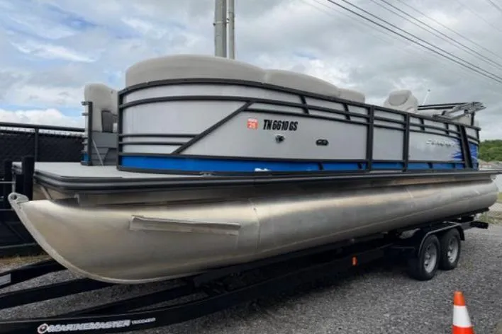 The Image of 2023 Starcraft SLS 5 pontoon boat on trailer, parked outdoors. - 0