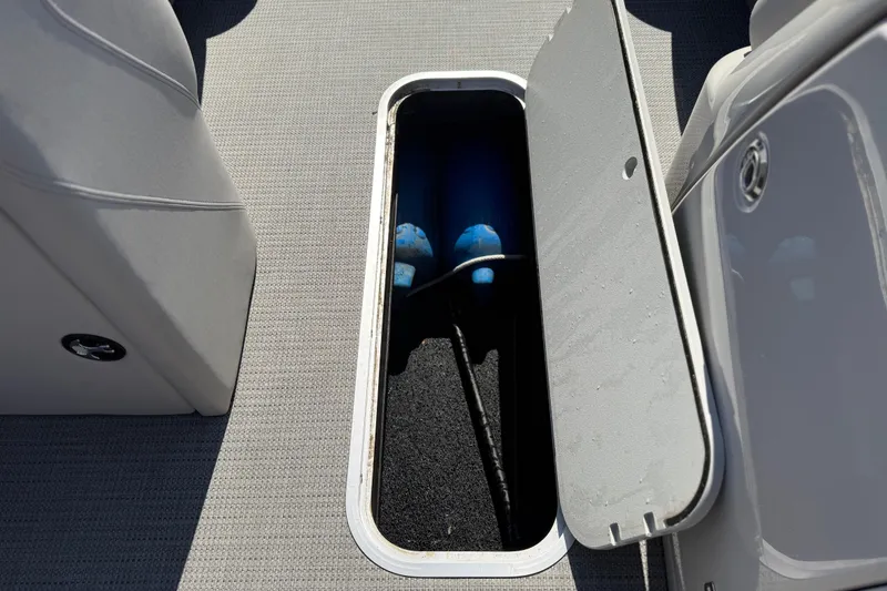 Slide: The Image of Storage compartment on 2023 Starcraft SLS 5 boat, featuring open hatch and interior view. - 13
