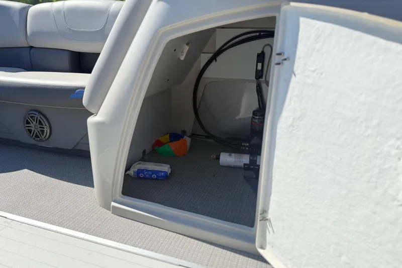 Slide: The Image of Storage compartment in 2023 Starcraft SLS 5 boat, featuring seating and equipment. - 14