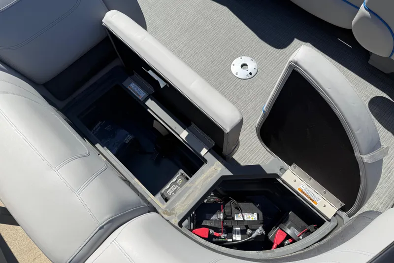 Slide: The Image of Open storage compartment in 2023 Starcraft SLS 5 boat, revealing battery and wiring. - 18