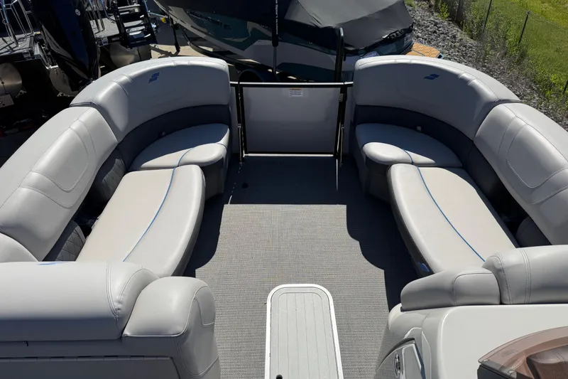 Slide: The Image of Luxurious seating area on a 2023 Starcraft SLS 5 pontoon boat, featuring plush gray upholstery. - 2