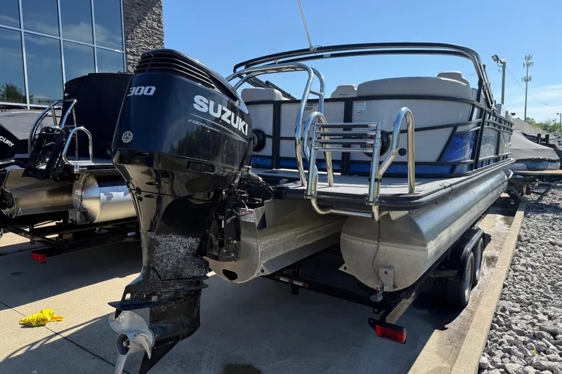 Slide: The Image of 2023 Starcraft SLS 5 pontoon boat with Suzuki 300 outboard motor, parked outdoors. - 21