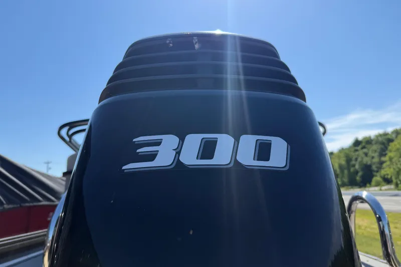 Slide: The Image of Close-up of a 2023 Starcraft SLS 5 boat engine with "300" label under clear sky. - 22