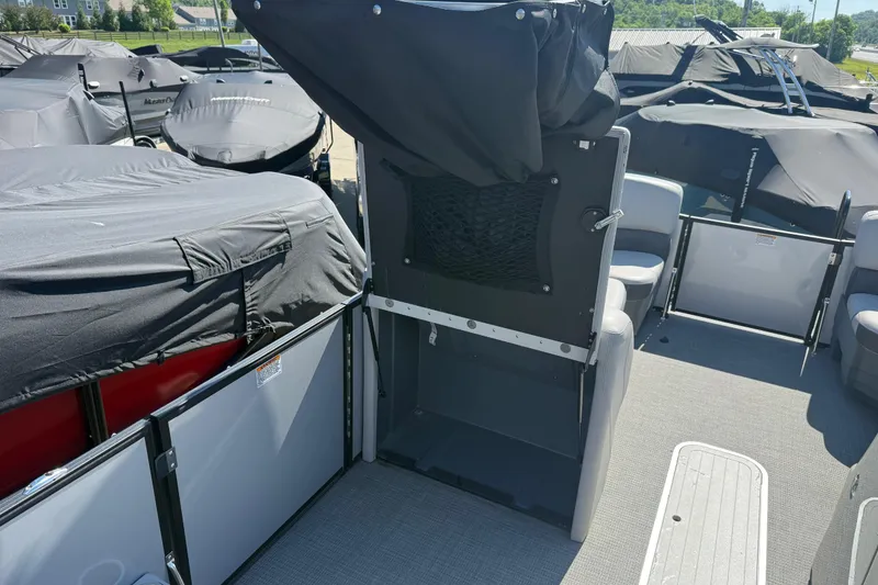 Slide: The Image of 2023 Starcraft SLS 5 boat interior with covered seating and open deck area. - 6