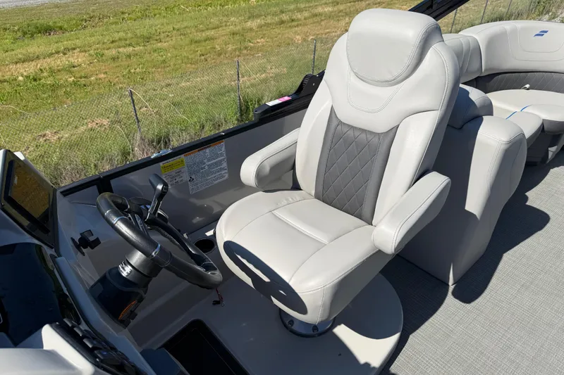 Slide: The Image of Captain's seat of 2023 Starcraft SLS 5 boat with steering wheel and controls. - 8