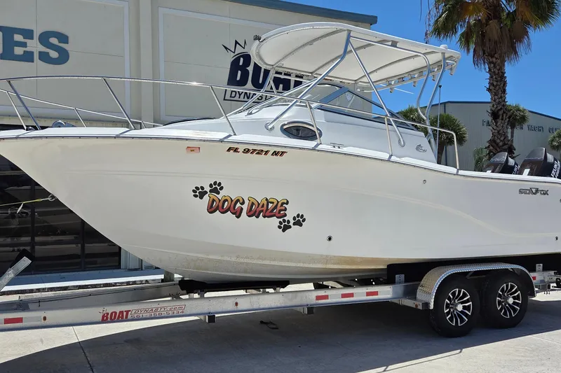 The Image of 2009 Sea Fox 256 Walk Around boat named "Dog Daze" on a trailer. - 0