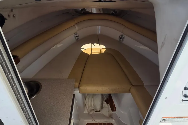 Slide: The Image of Interior cabin of 2009 Sea Fox 256 Walk Around boat with cushioned seating and compact sink. - 10